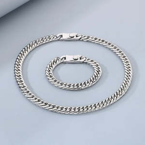 Detail of silver stainless steel Cuban link chain jewelry set with a unique square clasp