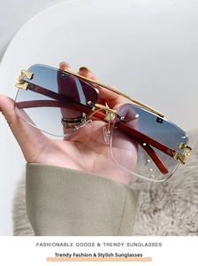 Detail of gradient blue lenses and luxury wood temples on rimless aviator sunglasses