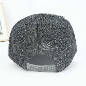 Detail of grey sequin baseball cap showing shiny texture and adjustable snapback closure