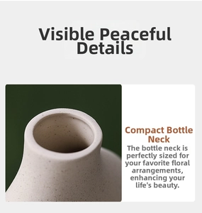 Detail of matte cream ceramic vase with fine speckled texture and a compact neck design