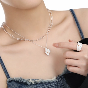 Irregular silver S925 necklace and ring set with orange stones on a model