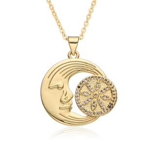 Macro shot of gold sun and moon face pendant necklace with micro-paved zircons