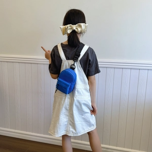 Blue mini nylon crossbody bag for sports with adjustable strap shown on a model