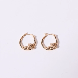 Detailed close-up of golden hoop earrings featuring Cupid angel relief charms on white backdrop