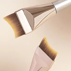 Moon-shaped seamless foundation brush with soft dual-tone bristles and metallic handle