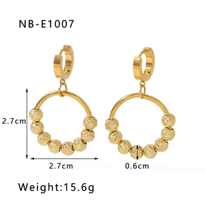 Detailed view of 18K gold plated stainless steel hoop earrings with ten textured beads
