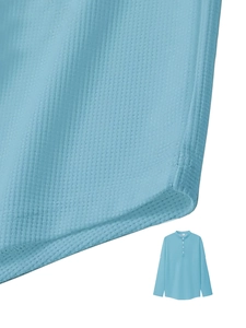 Close-up of light blue waffle texture fabric and button neckline on long sleeve polo shirt