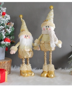 Detail of Christmas Santa and snowman plush dolls in festive gold and beige textile fabric
