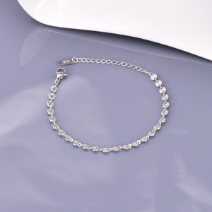 Detail of silver chain bracelet with 18K engraved tag and adjustable lobster clasp