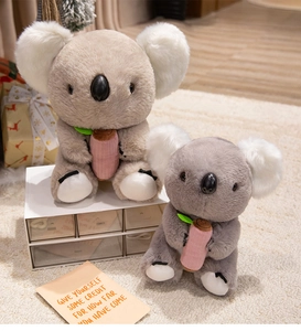 Close-up of soft plush koala toys with fluffy ears in a cozy home setting