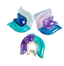 Close-up of multi-colored concentrated laundry detergent pods on a white background