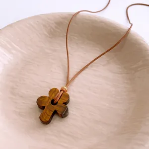 Tiger eye stone flower pendant necklace with brown wax cord and a gold bead accent