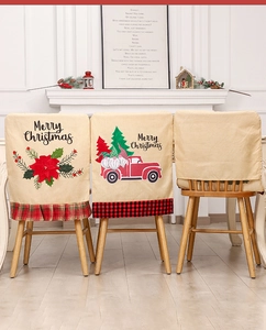 Detail of Christmas chair covers featuring holiday floral and truck patterns in linen