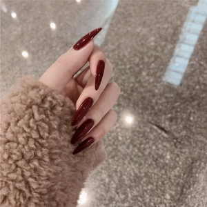 Glossy burgundy stiletto press-on nails in long artistic pointed style for women