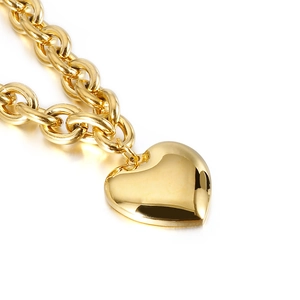 Gold heart pendant necklace with chunky stainless steel chain on a white background