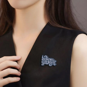 Creative enamel letter brooch featuring 'believe IN yourself' on a dark blue background