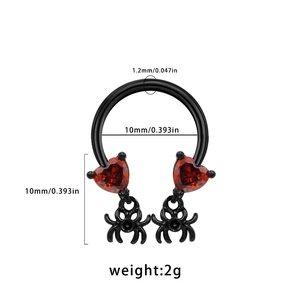 Detail of 1.2mm black horseshoe ring with red heart stones and black spider charms