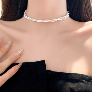 Elegant double-layered pearl choker necklace with zircon twist design on a female model