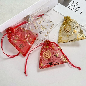 Organza drawstring gift bags with gold foil snowflake and star patterns in assorted colors