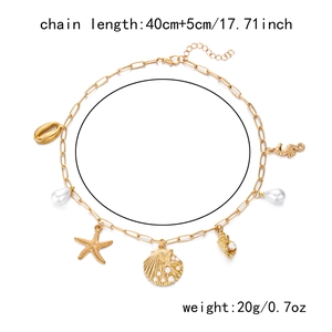 Close-up of gold ocean bracelet with shell charms and length specifications