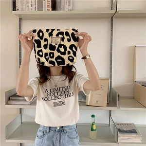 Detailed close-up of a leopard print canvas tote bag featuring stylish white lettering print