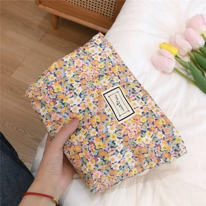 Detail of floral cotton pouch with floral pattern and Time to Party woven label
