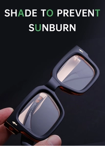 Detail view of square black frame glasses with gold metal accents on the side temple
