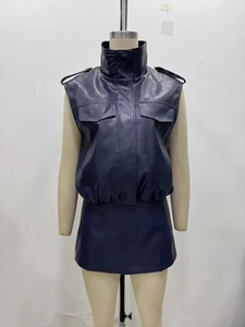 Detail of navy faux leather two-piece set with cargo vest and mini skirt on mannequin