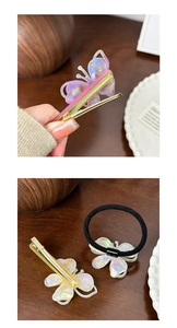 Detail of gold hair clip and black elastic band featuring translucent acetate butterflies