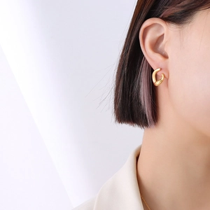 French style double layer C-shaped gold hoop earrings worn on a female ear