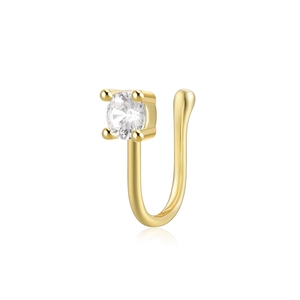 Macro detail of gold U-shaped nose cuff featuring a sparkling four-prong set round zircon