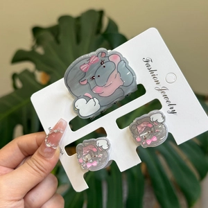 Three-piece gray hippo acrylic hair clip set shown on a white display card