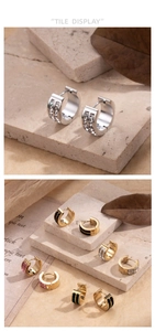 Detail of stainless steel hoop earrings with sparkling zircons and colored enamel accents