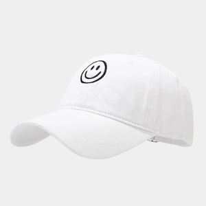 Close-up of black smiley face embroidery on a white cotton twill baseball cap