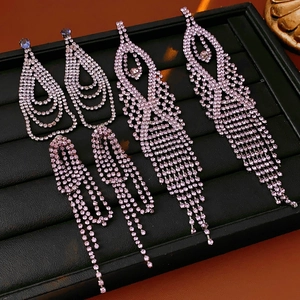 Detailed close-up of crystal drop tassel earrings with purple stones on display