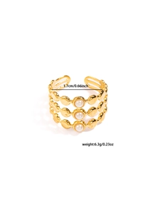 Detailed close-up of a triple-layer gold ring featuring three vertically aligned white pearls