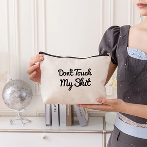 Portable canvas makeup bag with Don't Touch My Shit print and black zipper closure
