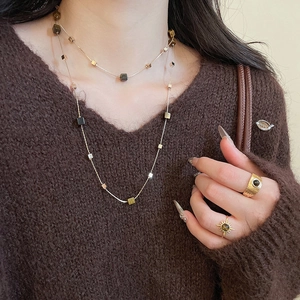 Close-up of double layer tiger eye pendant necklace and matching sunburst rings on model