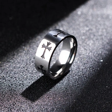 Detailed macro view of silver stainless steel ring with embossed cross patterns