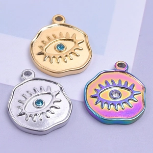 Macro detail of Evil Eye pendants in gold, silver, and iridescent 18k plated finishes