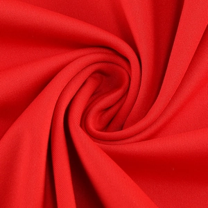 Close-up of red mesh patchwork fabric with fine texture and elegant soft draping
