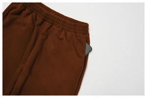 Detail of high-waist sweatpants showing elastic waistband and deep side pocket utility