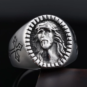 Detailed macro view of vintage stainless steel ring with Jesus relief and cross engraving
