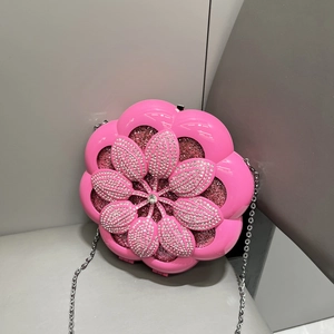 Close-up of pink flower shaped evening bag with sparkling rhinestones and silver chain