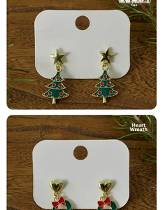 Detail view of festive Christmas tree and heart wreath earrings on display card