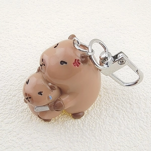 Detail of cute resin capybara keychains featuring expressive faces and durable metal hooks