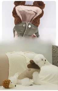 Detail of winter dog coat with plush bear ears hood and snap button closure