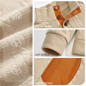 Detail of men's quilted oatmeal sweatshirt showing ribbed cuffs and orange inner placket