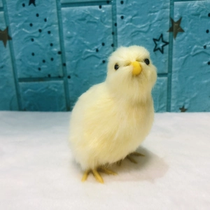 Realistic yellow plush chick toy for Easter decoration on blue patterned background