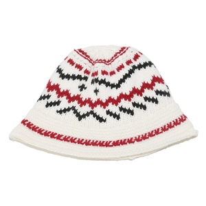 Detailed knit texture of a bohemian bucket hat with red and black wave patterns